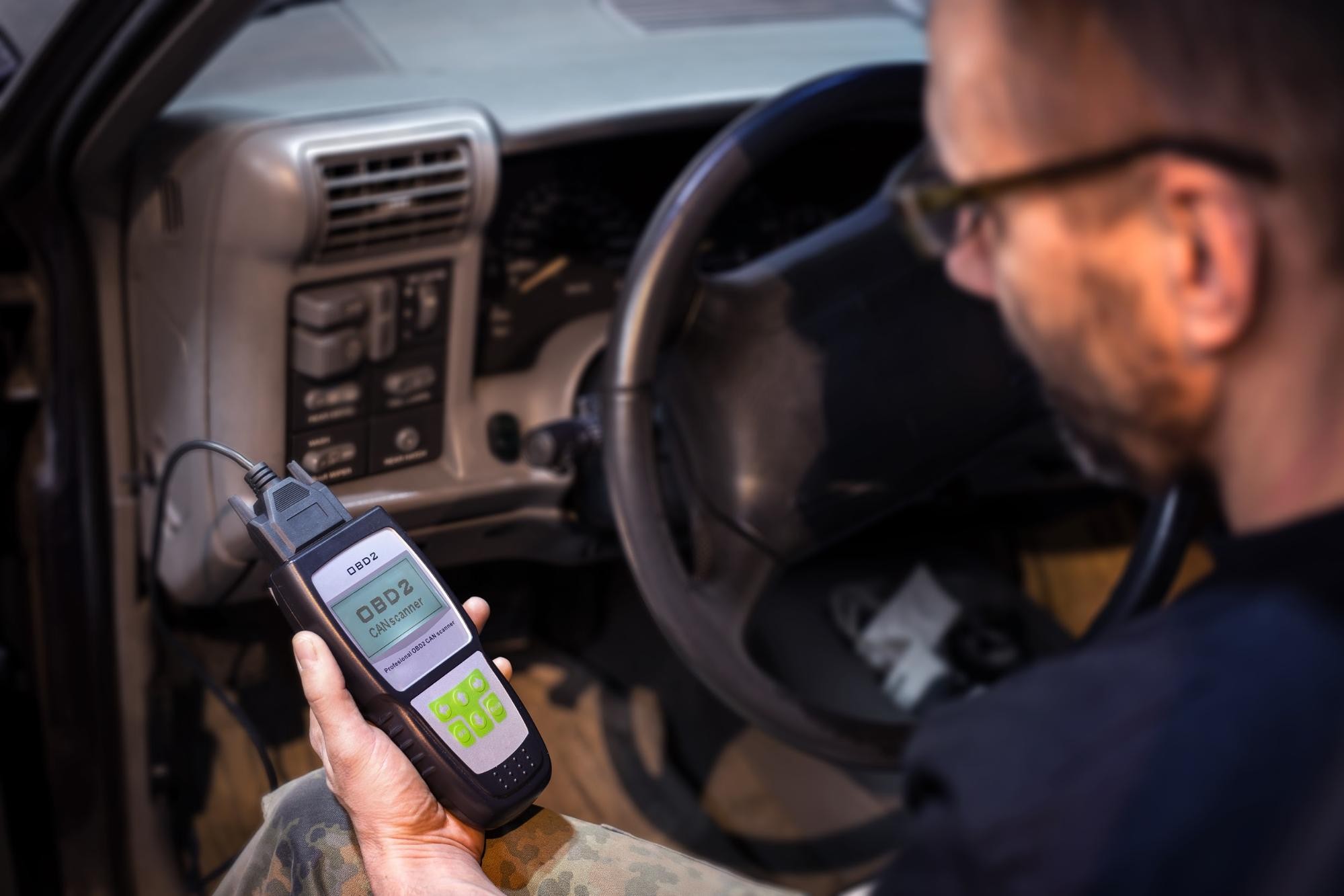 Mechanic extracting data from OBDII port