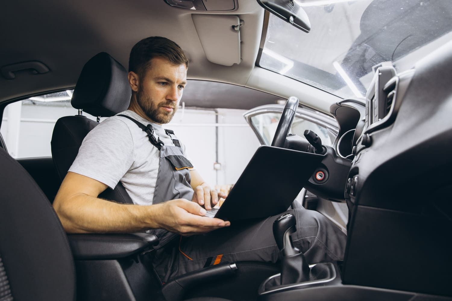 Mechanic Checking OBD on Laptop