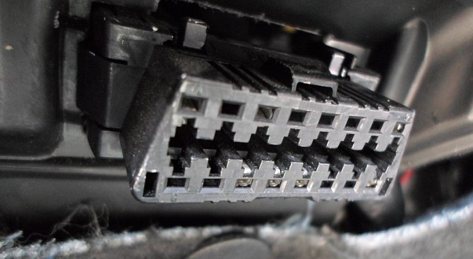 OBD-II port under the dashboard for car diagnostics