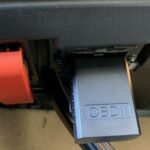 Kobra OBD2 Scanner plugged into OBD2 port with indicator light on