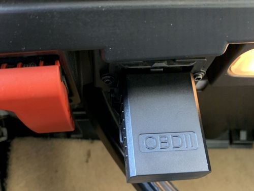 Kobra OBD2 Scanner plugged into OBD2 port with indicator light on