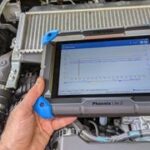 Topdon Phoenix Lite 2 OBD2 scanner over car engine