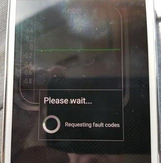 Trekpow OBD2 scanner displaying diagnostic trouble codes (DTCs) on its screen, showing error codes like P0420 and P0300