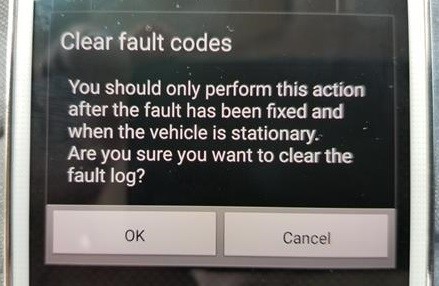 Clearing fault codes on a Trekpow OBD2 scanner, illustrating the process of removing error codes from the vehicle's computer